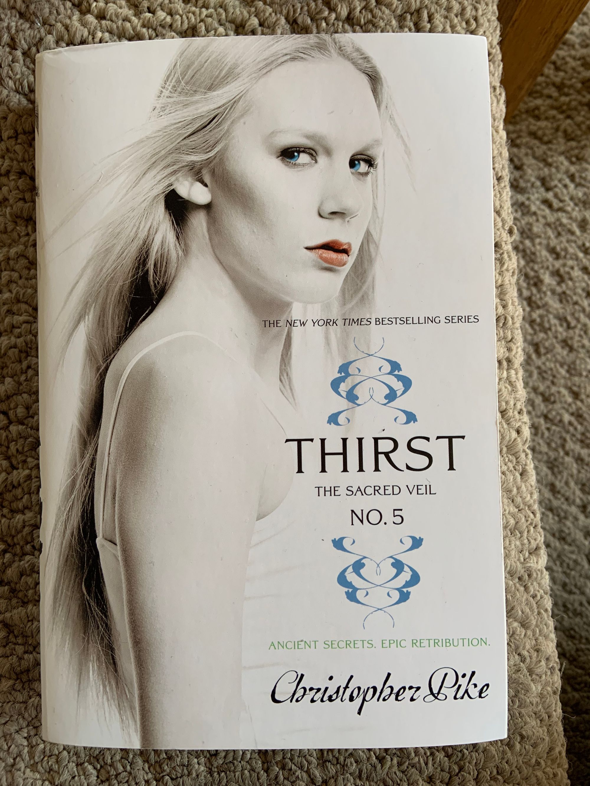 Paperback copy of Thirst No. 5: The Sacred Veil by Christopher Pike featuring a blonde-haired white woman with blue eyes