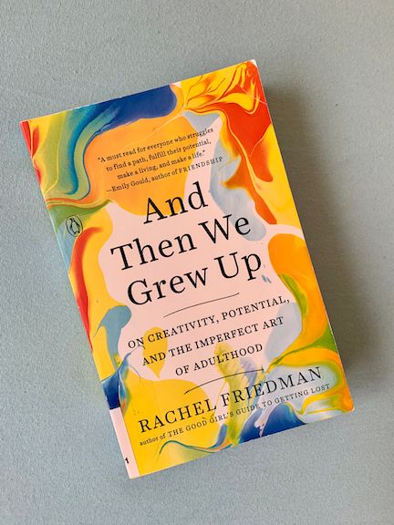 Paperback copy of And Then We Grew Up by Rachel Friedman featuring a splash of bright colours