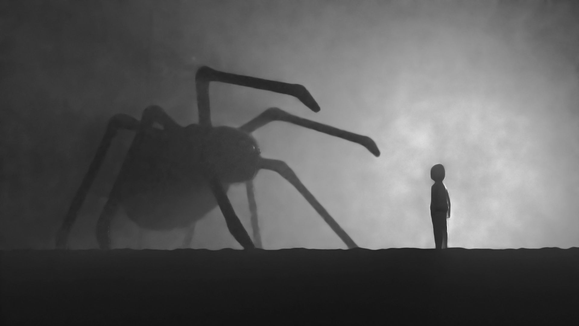 black and white image of a small boy facing a gigantic arachnid