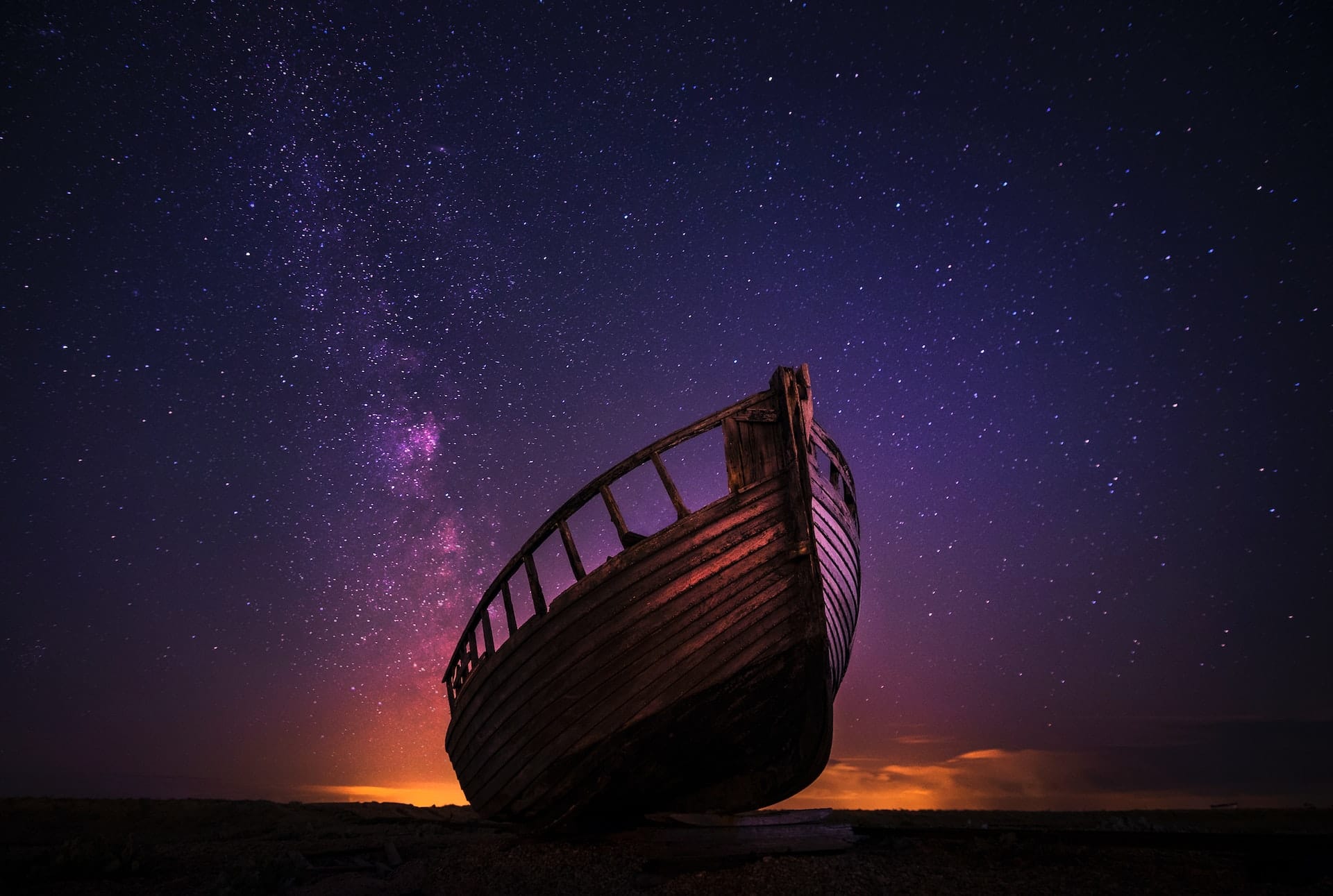 wooden boat under a night sky