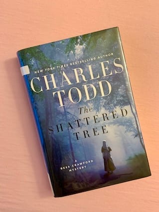 hardback copy of The Shattered Tree by Charles Todd featuring a nurse walking into the misty woods