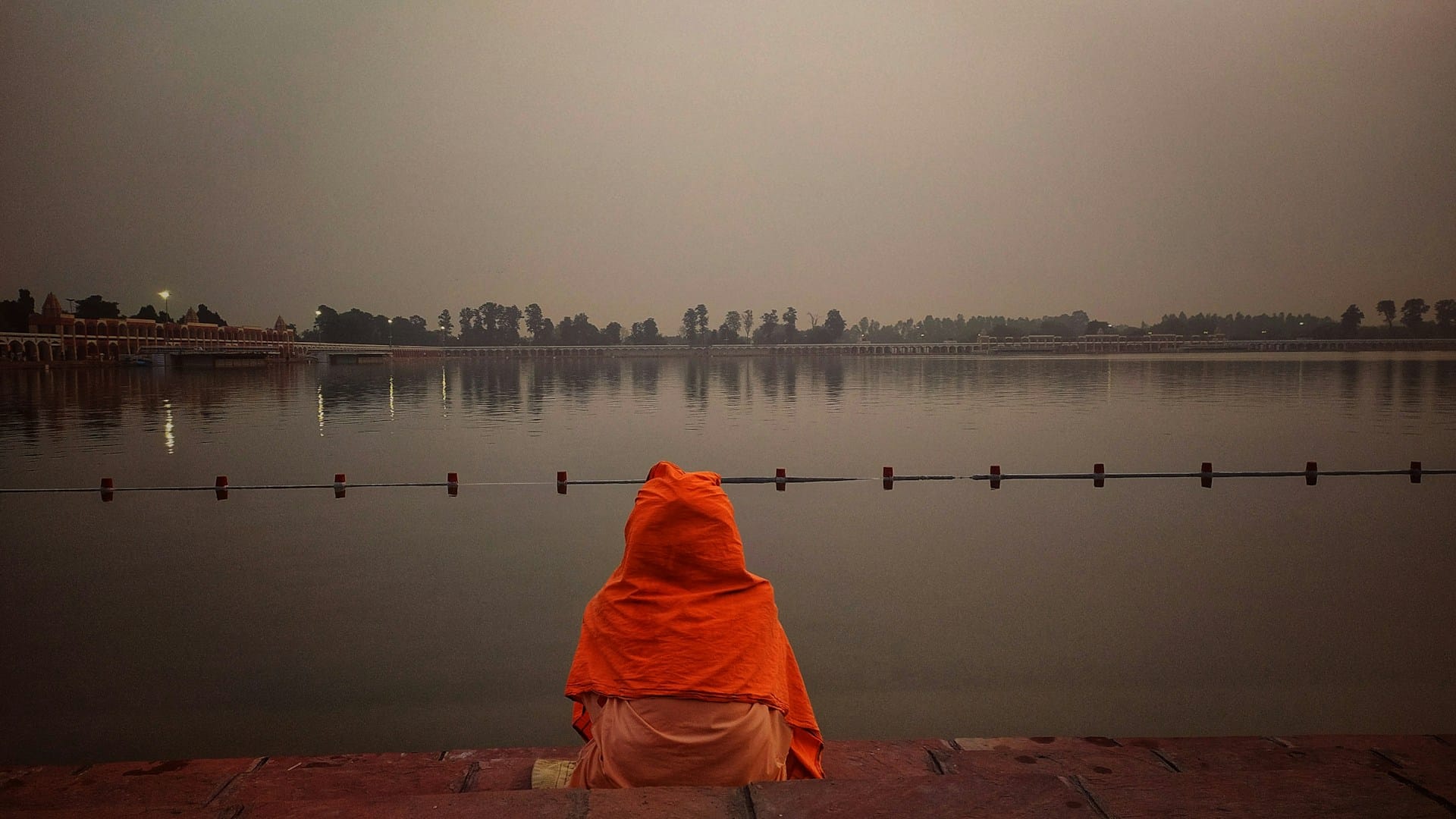 ascetic sitting by the banks of a river in India