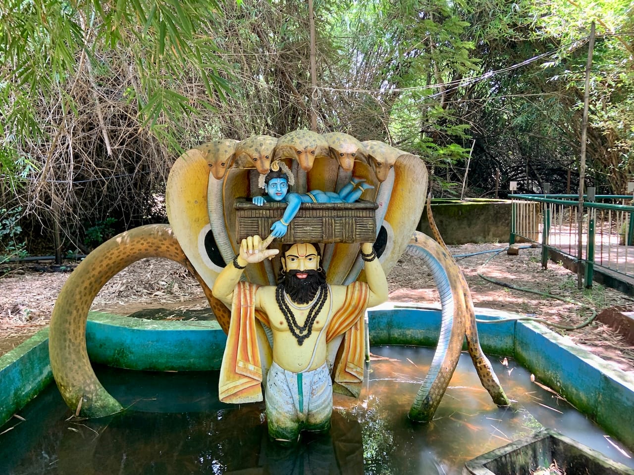 statue of baby Krishna being carried in a basket