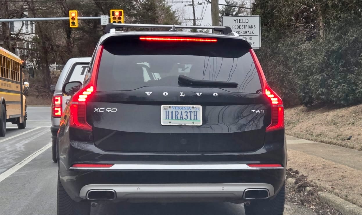 The rear of a black Volvo SUV with a license plate reading H1RA3TH