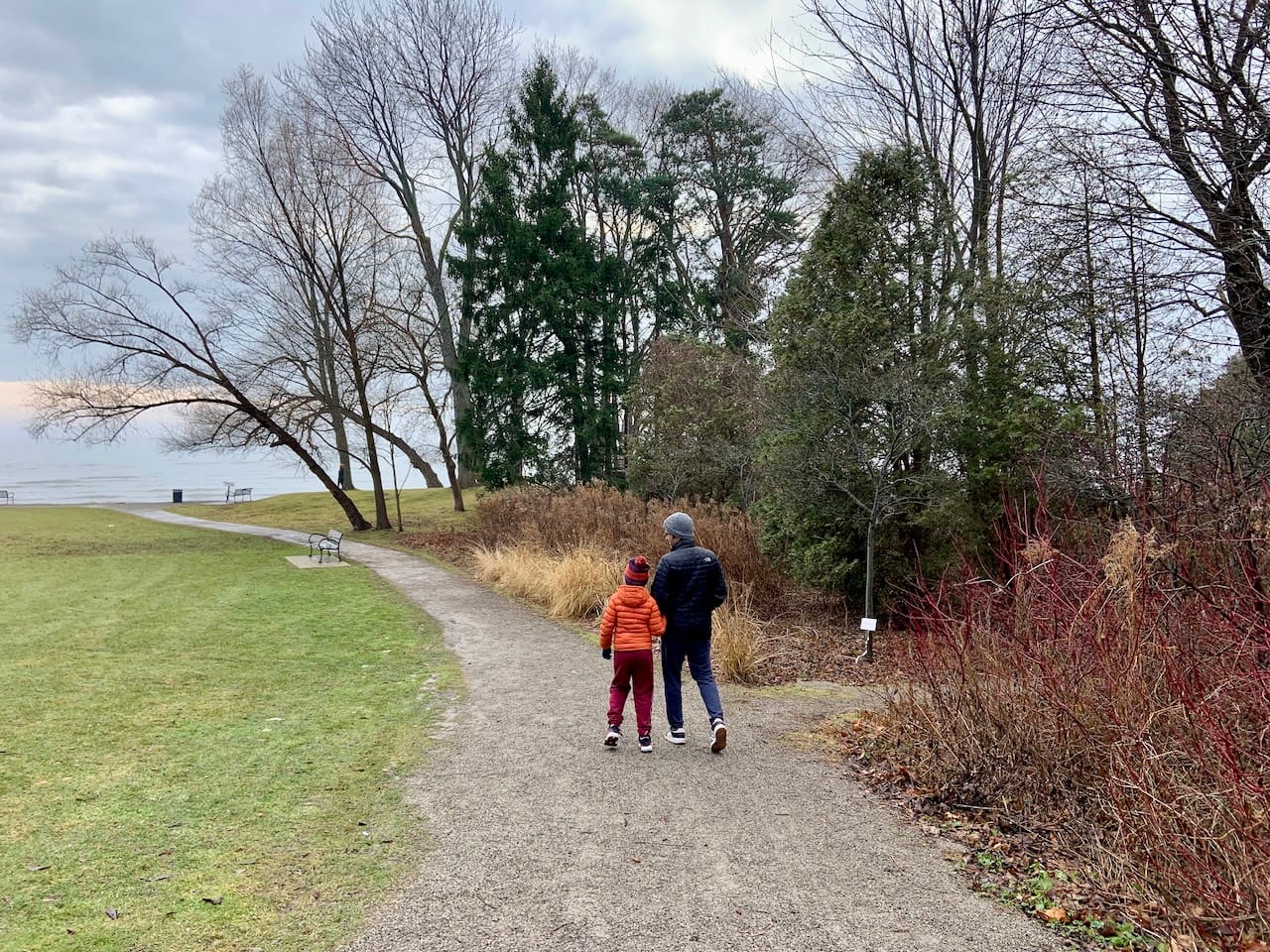 D and KrA walking down a trail in the woods leading to Lake Ontario