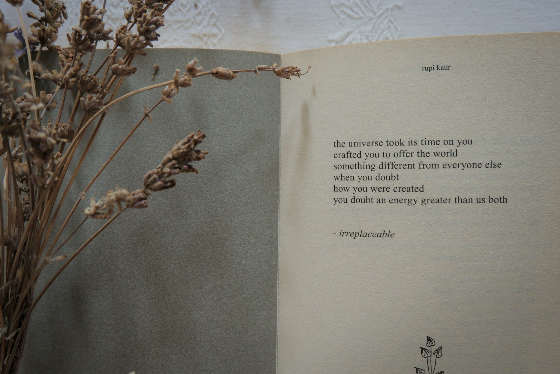 image of dried flowers against a book of poems by Rupi Kaur 