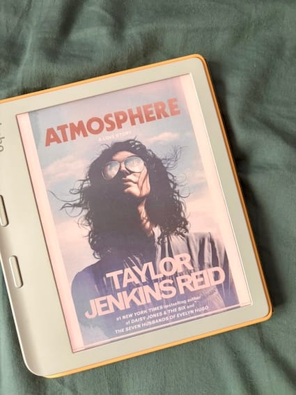 ebook cover of Atmosphere by Taylor Jenkins Reid featuring a woman wearing sunglasses reflecting a rocket