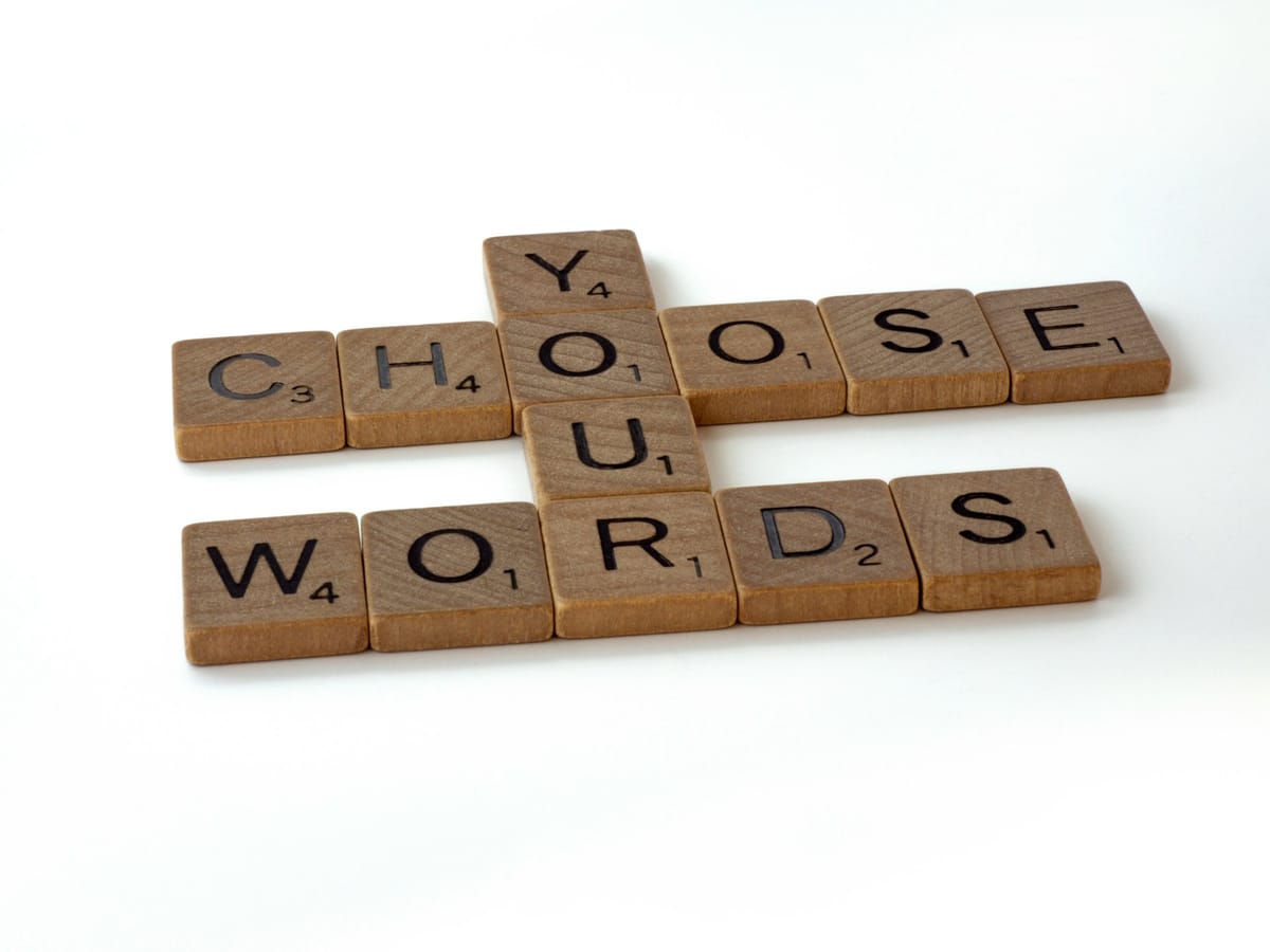 scrabble tiles arranged to read 'Choose Your Words'