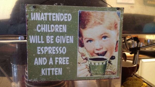 poster in a coffee shop showing a child with a coffee cup