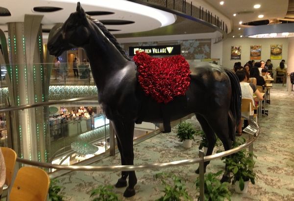 statue of a black horse at a mall