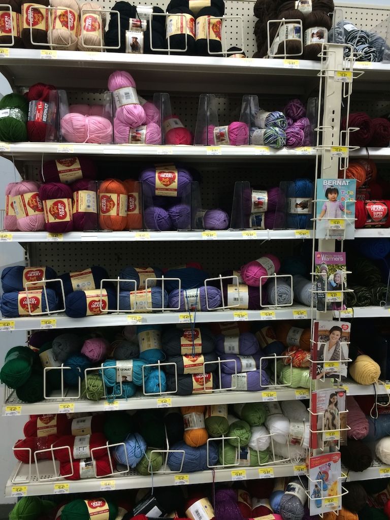 shelves stocked with knitting yarns of many colours