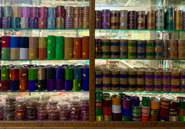 Rows of colourful bangles displayed in a shop window