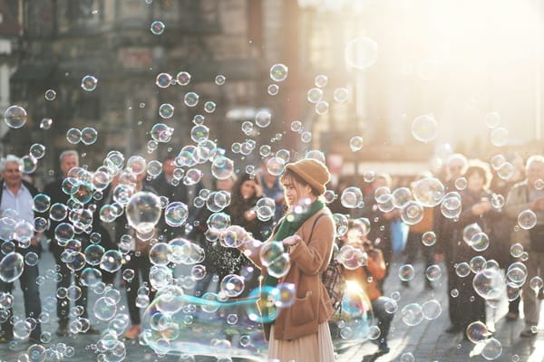 happy woman on a street surrounded by bubbles