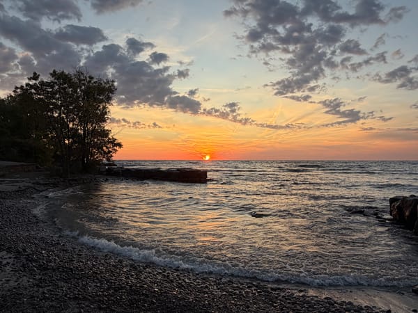 the sun rising over Lake Ontario