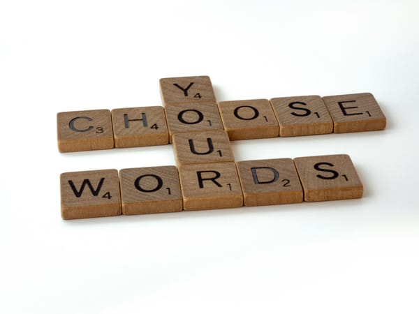 scrabble tiles arranged to read 'Choose Your Words'