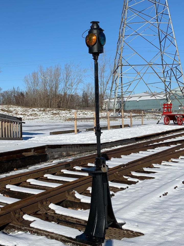 old train signal with a padlock on its base