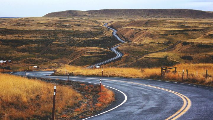 winding concrete road leading up a hill