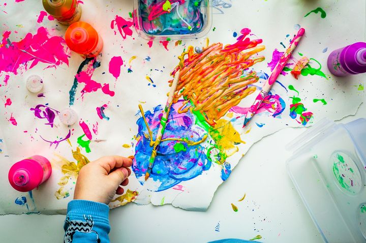 colourful brush strokes on a sheet of paper by a child's hand