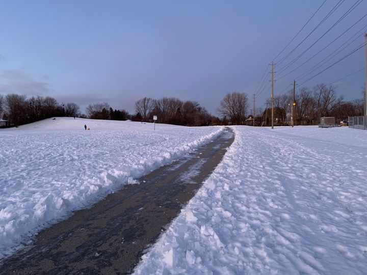 a path plowed through a field of snow