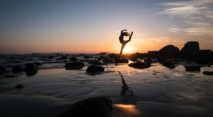 dancer in mid-air on a beach