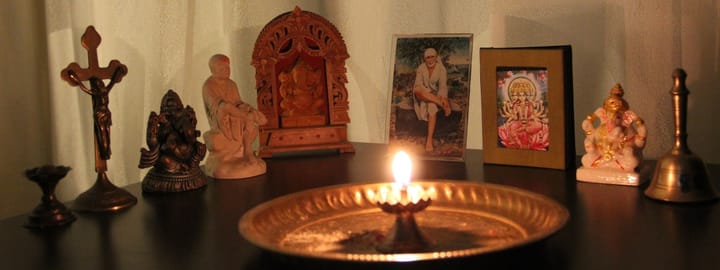 altar of gods around a brass plate with a lamp lit on it