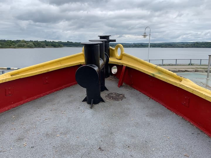 image of a shore from the prow of a boat