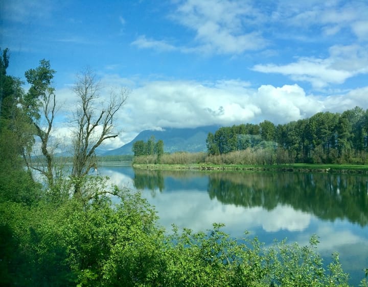 view of a lake flanked by mountain ranges on the opposite shore