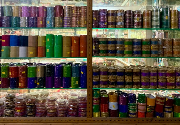 Rows of colourful bangles displayed in a shop window