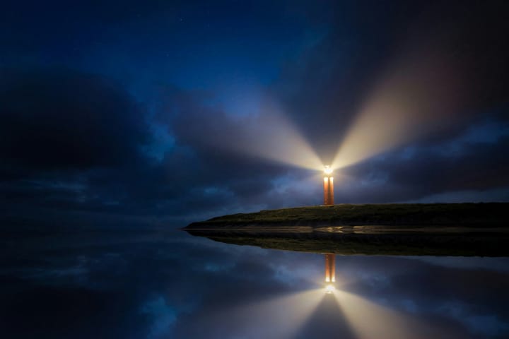 a lighthouse shining in the dark