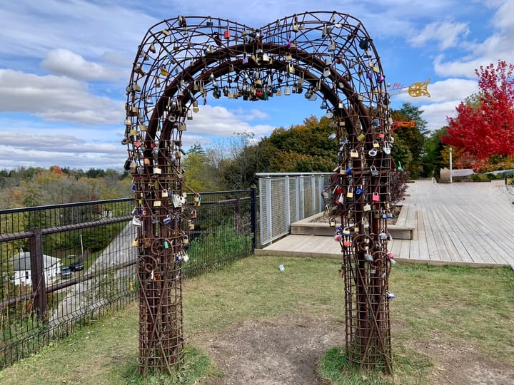 an iron archway installation with many locks affixed to it