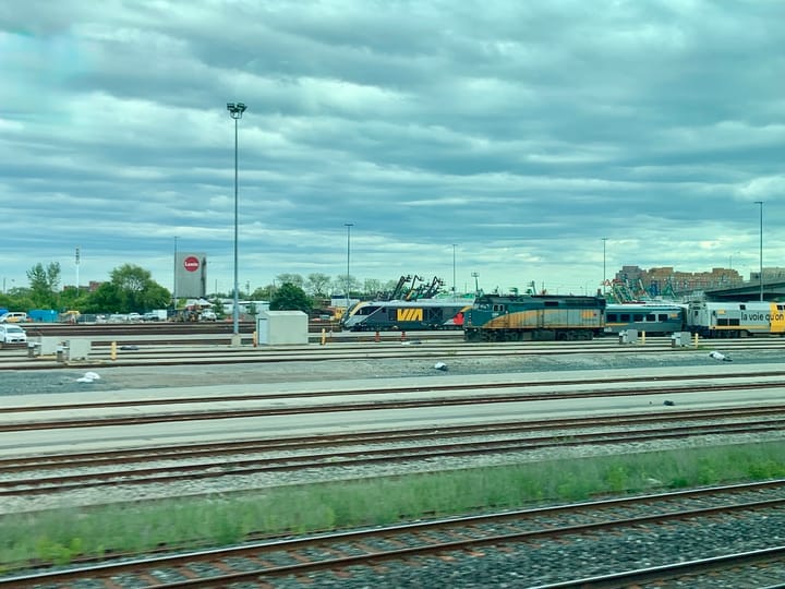 trains standing on several train tracks running parallel to each other