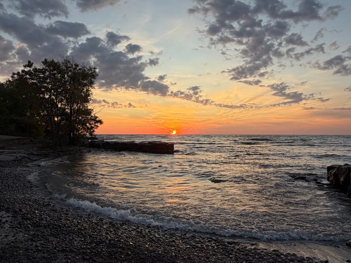 the sun rising over Lake Ontario