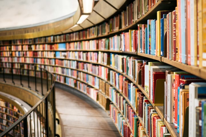 a curved library shelf filled with books